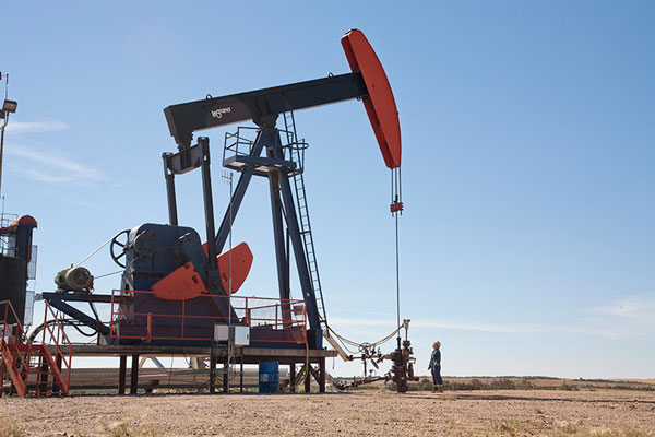 An employee inspects a pumpjack at Husky's Pikes Peak South oil site in Saskatchewan. PHOTO Husky Energy